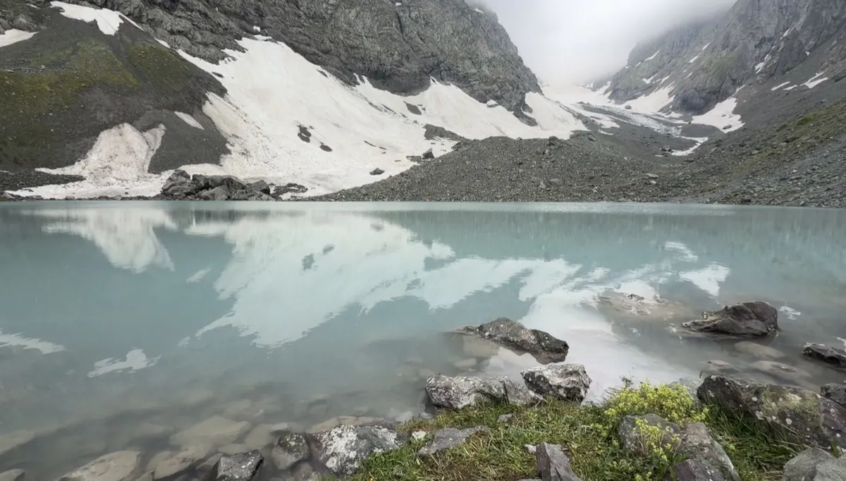 Sitting above a turquoise mountain lake on a hike